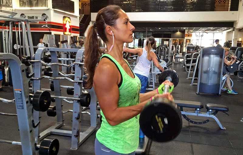 Woman training with dumbbells in the gym