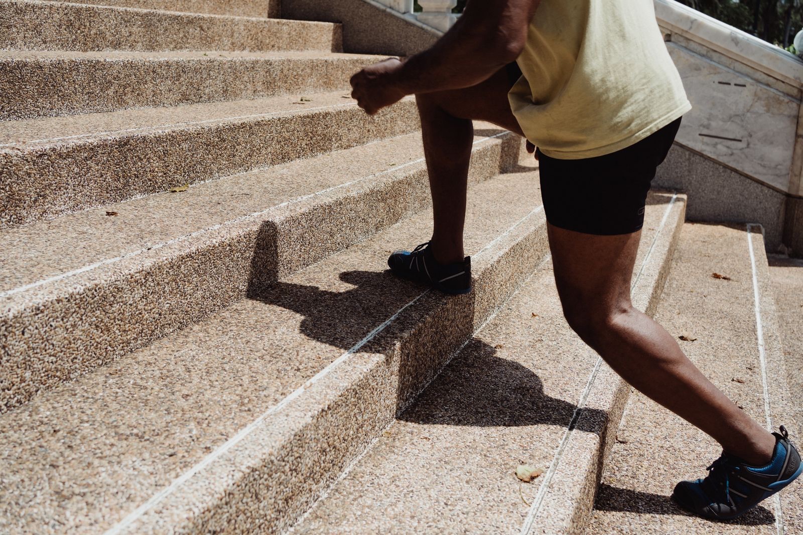 A man running up a flight of outdoor stone steps