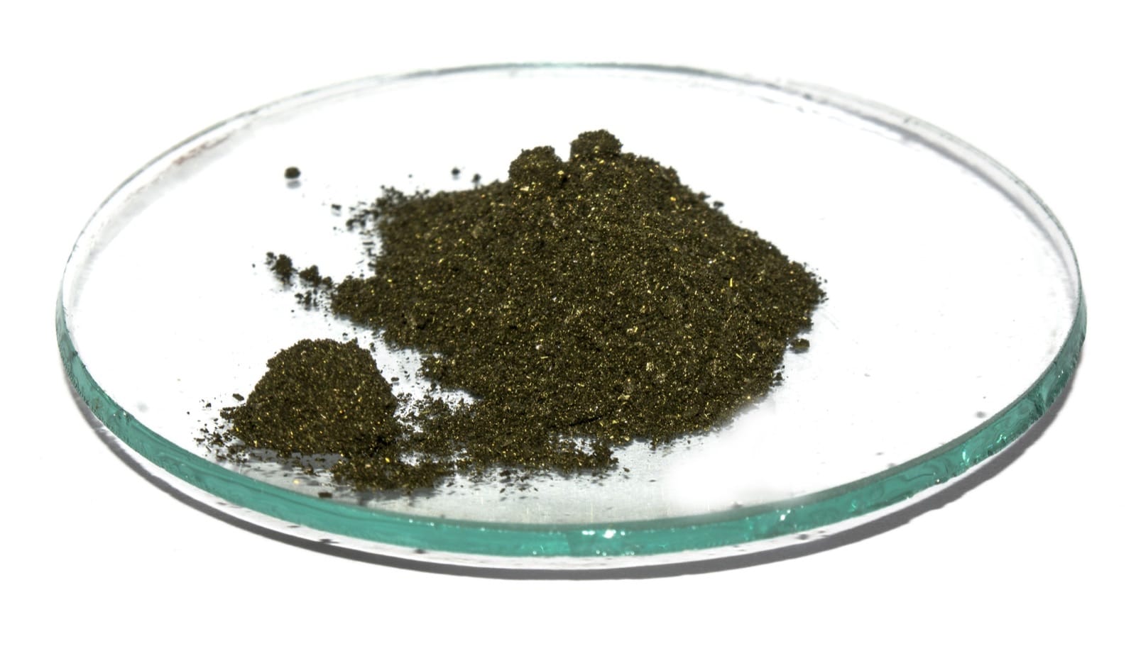 Raw methylene blue as a dark bronze-green crystalline powder on a watch glass