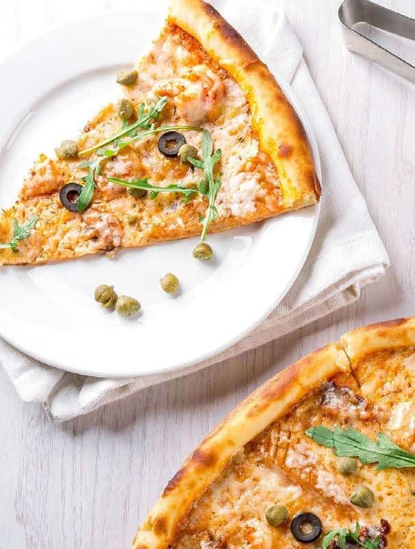Pizza on a restaurant table — high palatability, high energy density