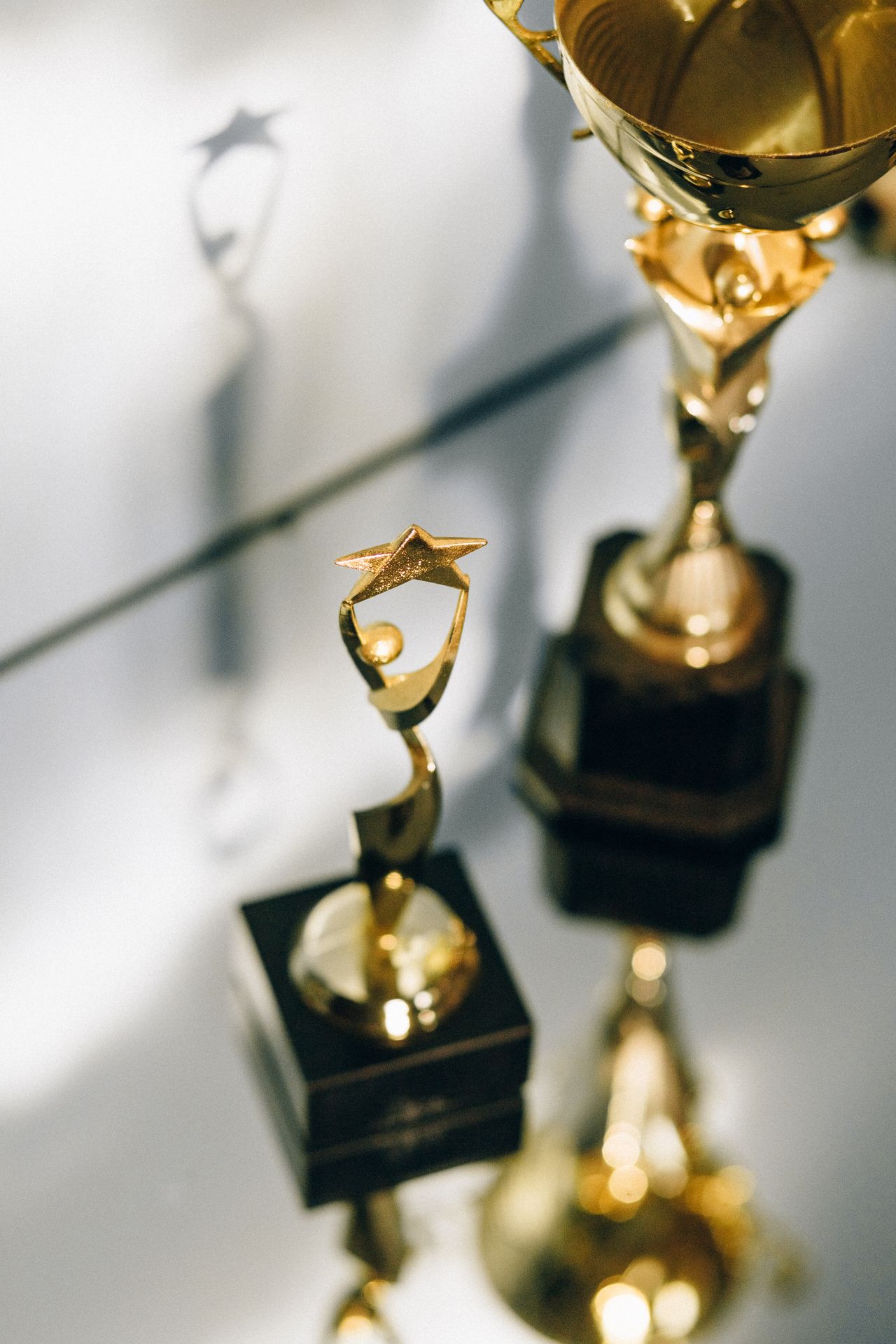 Golden star award trophies on a reflective surface