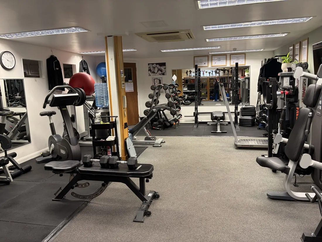 Squat rack, bench and loaded barbells in Pete Gawtry's private Leeds studio