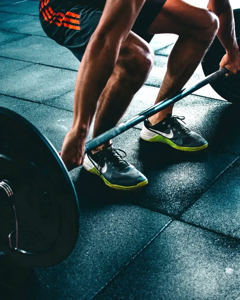 Loaded barbell and plates on the gym floor