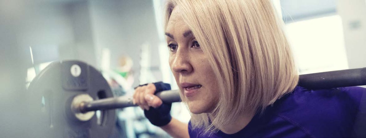 Woman strength training in midlife