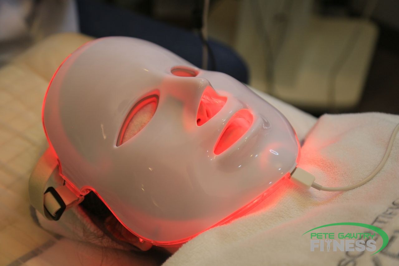 Person wearing a red LED light therapy face mask