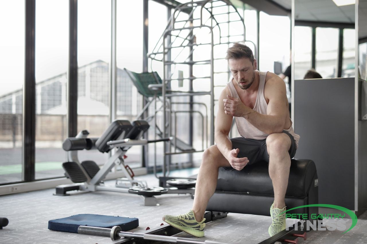 Muscular male athlete resting after a weightlifting workout